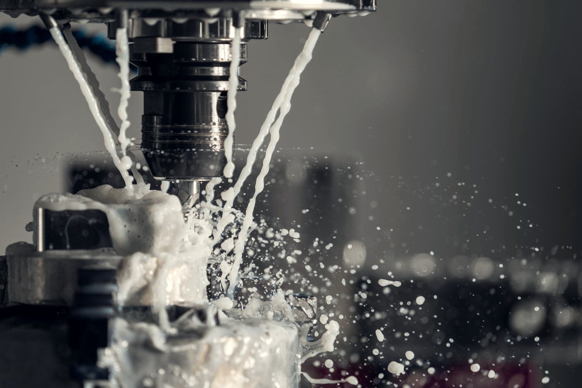 CNC spindle cutting metal under a flood of coolant